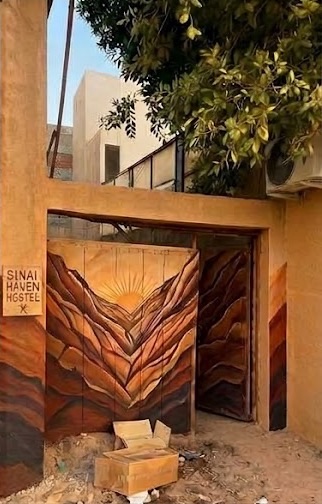 The painted gate of Sinai Haven: a sun rising in a canyon